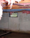 Nevada and California crawl space with vents, showing mold, rot, and fiberglass insulation dripping off the ceiling.